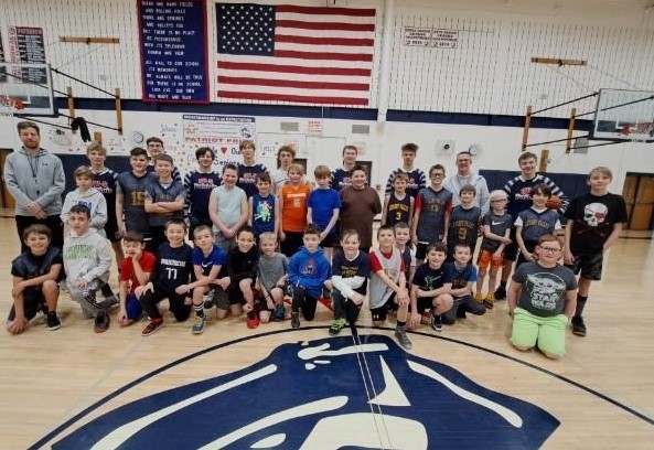 Varsity Boys Basketball Players Teach Biddy Basketball Players in a Basketball Clinic