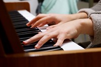 Close up of hands on piano